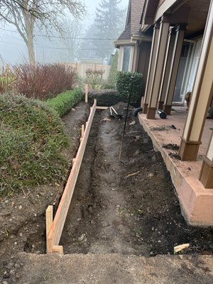 ADA Ramp and retaining wall - This was the start of a large full home remodel for a business owner starting a retirement home. We started by pulling up the old sidewalk and stairs, dug out and formed the retaining wall to set of for an ADA rated ramp dyed to match the color of the patio