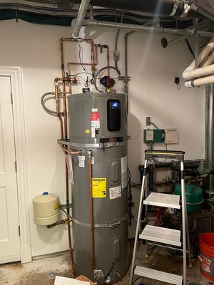 HEAT PUMP INSTALLATION - Existing 98 gallon direct vent water heater had leak in a basement. location was in a fully finished and occupied bedroom, game room and home theatre. Staircase to remove and replace existing unit required extra care. Client had unique requirements for his ranch style home. Energy efficiency and heat recovery was of the essence in this whole project. Client has solar and extra units were spared each month so the decision was made to go with the Heat pump technology. A thermostat was added for a constant temperature and recirculation system with smart flow meter was installed for optimum performance. Leak guard device is also installed for any future leak preventive measure. HEAT PUMP INSTALLATION - Existing 98 gallon direct vent water heater had leak in a basement. location was in a fully finished and occupied bedroom, game room and home theatre. Staircase to remove and replace existing unit required extra care. Client had unique requirements for his ranch style home. Energy efficiency and heat recovery was of the essence in this whole project. Client has solar and extra units were spared each month so the decision was made to go with the Heat pump technology. A thermostat was added for a constant temperature and recirculation system with smart flow meter was installed for optimum performance. Leak guard device is also installed for any future leak preventive measure.