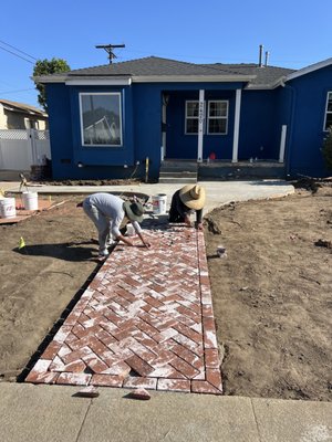Burrit Ave: Brick Paver Walkway - We installed a custom brick paver walkway to create a welcoming entrance and improve the overall flow of the landscape.