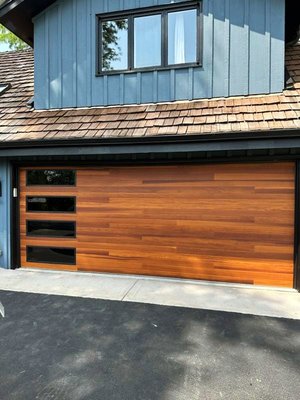 Garage Door Install - Planks with Windows - This homeowner had an older door, which they were looking to update to a more modern look. They chose to go with the CHI Planks door, in cedar color, with stacked tinted windows to make their home pop! Garage Door Install - Planks with Windows - This homeowner had an older door, which they were looking to update to a more modern look. They chose to go with the CHI Planks door, in cedar color, with stacked tinted windows to make their home pop!