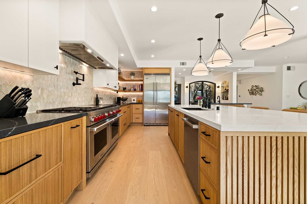 Kitchen Remodel in Escondido - As shown in the photos, we remodeled the entire kitchen and dining area. We used custom made cabinetry with 2 different colors for the counter tops and the cabinets itself. The Green wallpaper background makes everything stand out with a warm and naturalistic atmosphere.