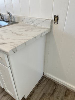 Apartment Renovation - This remodel was of a unit that was in desperate need of some TLC. The unit was gutted, clearing the way for a fresh canvas. We prepped and painted the entire unit, installed new laminate flooring throughout,