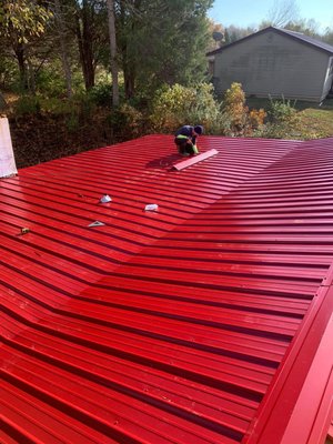Metal roof replacement - In this recent metal roof replacement project, our team installed a bold, fire-engine red corrugated metal roofing system on a residential home in the Louisville, KY area. The photos capture the precise installation process, with a crew member carefully placing and securing panels over the existing structure. The distinctive zigzag/Chevron pattern showcases excellent attention to detail in alignment and overlap for maximum weather resistance. This durable metal roof upgrade provides long-lasting protection against Kentucky's storms, snow, and wind, while boosting energy efficiency and curb appeal with its striking color. Solid framing prep and professional fastening ensure a leak-free, low-maintenance finish that will last decades. Proud of another high-quality metal roofing install! #MetalRoofReplacement #RedMetalRoof #CorrugatedMetalRoof #MetalRoofing #RoofingContractor Metal roof replacement - In this recent metal roof replacement project, our team installed a bold, fire-engine red corrugated metal roofing system on a residential home in the Louisville, KY area. The photos capture the precise installation process, with a crew member carefully placing and securing panels over the existing structure. The distinctive zigzag/Chevron pattern showcases excellent attention to detail in alignment and overlap for maximum weather resistance. This durable metal roof upgrade provides long-lasting protection against Kentucky's storms, snow, and wind, while boosting energy efficiency and curb appeal with its striking color. Solid framing prep and professional fastening ensure a leak-free, low-maintenance finish that will last decades. Proud of another high-quality metal roofing install! #MetalRoofReplacement #RedMetalRoof #CorrugatedMetalRoof #MetalRoofing #RoofingContractor