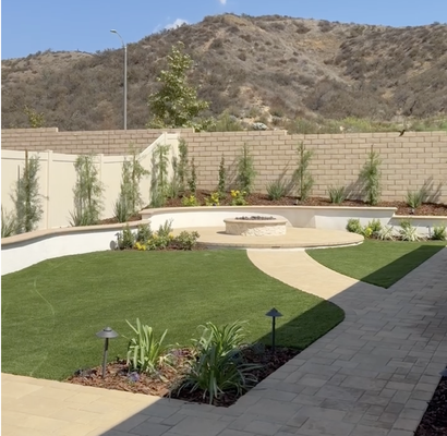 Classic modern design with pavers, outdoor kitchen and fire pit - Our client wanted a clean and classic look. We made planter walls to compliment the design using Santa Barbara smooth stucco. We created walkways and patio areas with gorgeous pavers, adding texture and interest. The design was complete with an outdoor kitchen and fire pit, making the client's vision a reality. Classic modern design with pavers, outdoor kitchen and fire pit - Our client wanted a clean and classic look. We made planter walls to compliment the design using Santa Barbara smooth stucco. We created walkways and patio areas with gorgeous pavers, adding texture and interest. The design was complete with an outdoor kitchen and fire pit, making the client's vision a reality.
