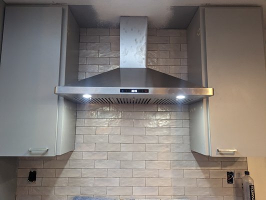 Cabinet Removal, Range Hood Install and Tiling - This client needed some cabinets removed and demo'd, then a new range hood installed with a tile background to refresh the look of their kitchen, and get better venting as well. While not a full kitchen remodel, this update made a huge difference in the function and appearance of their kitchen.