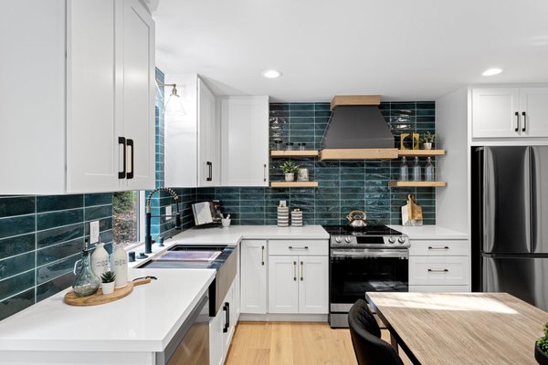 Modern 2-Story DADU with Permits – Seattle - This beautiful standalone home boasts a garage, private yard, and a spacious driveway. The interior is beautifully accented with green / blue tones, highlighted in the kitchen backsplash and throughout the doors, adding a touch of elegance and vibrancy to the living space.

The main level features an expansive layout with large windows that flood the space with natural light. Highlighting the stunning hardwood floors that are truly a standout element.
This kitchen is equipped with modern amenities while still fostering a cozy and welcoming environment, making it ideal for family game nights and social gatherings with friends. The design thoughtfully separates the entertainment areas from the upstairs bedrooms and office space, ensuring that all entertaining activities remain conveniently located on the main level.

Project location: 304 32nd Ave E Seattle, WA