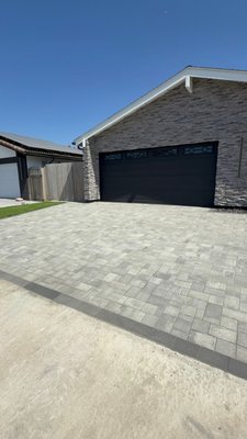 "Front-Yard Remodel" - Complete front yard transformation designed for both beauty and functionality. This project started with a bare dirt landscape and was upgraded into a clean, modern outdoor space with low maintenance in mind.
We installed a custom paver walkway and entry system using a multi-size pattern for a high-end look, paired with a contrasting border for definition. The design flows seamlessly from the driveway to the front door and wraps around the home for a cohesive feel.
Artificial turf was installed to create a lush, green lawn year-round with zero maintenance, perfectly framed around a raised circular planter. The planter was built with decorative block and filled with smooth river rock, creating a clean focal point around the existing tree.
Additional features include new planting areas with fresh flowers, decorative rock beds for proper drainage, and precise grading throughout the property to ensure long-term durability.
This project is a great example of how we turn plain, unused space into a polished, functional, and visually appealing landscape. "Front-Yard Remodel" - Complete front yard transformation designed for both beauty and functionality. This project started with a bare dirt landscape and was upgraded into a clean, modern outdoor space with low maintenance in mind.
We installed a custom paver walkway and entry system using a multi-size pattern for a high-end look, paired with a contrasting border for definition. The design flows seamlessly from the driveway to the front door and wraps around the home for a cohesive feel.
Artificial turf was installed to create a lush, green lawn year-round with zero maintenance, perfectly framed around a raised circular planter. The planter was built with decorative block and filled with smooth river rock, creating a clean focal point around the existing tree.
Additional features include new planting areas with fresh flowers, decorative rock beds for proper drainage, and precise grading throughout the property to ensure long-term durability.
This project is a great example of how we turn plain, unused space into a polished, functional, and visually appealing landscape.