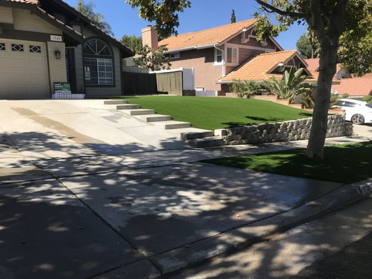 Block Wall and Artificial Grass in Corona - In Corona, California, a homeowner's vision for a stunning exterior became reality with Vision Turf and Pavers. Tasked with transforming the landscape, we installed a meticulously crafted block retaining wall, creating both functionality and aesthetic appeal. The retaining wall not only added structural integrity but also elevated the overall design of the property.

Complementing this, our team laid down lush artificial grass, blending beauty with low-maintenance practicality. The vibrant green turf not only enhanced the visual charm but also provided a year-round, immaculate lawn without the hassles of natural grass.

From meticulous planning to flawless execution, Vision Turf and Pavers turned a homeowner's dream into a tangible masterpiece. The synergy of the block retaining wall and artificial grass not only increased the property's curb appeal but also created an inviting outdoor space, making this Corona residence truly remarkable.