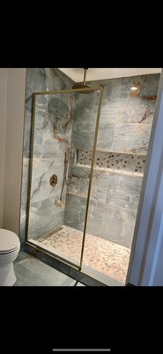 Bathroom Remodel - A bathroom with the tub was gutted and remodelled into a walk in shower with large format polished tiles for the walls and pebbled tiles for the shower floor and niche. Bathroom Remodel - A bathroom with the tub was gutted and remodelled into a walk in shower with large format polished tiles for the walls and pebbled tiles for the shower floor and niche.