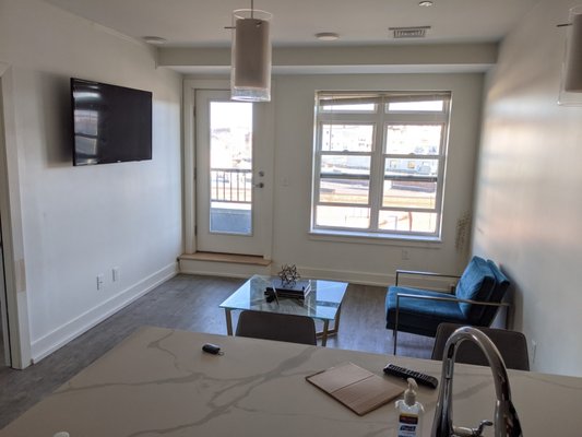 55" TV Installation, Boston - Full Motion TV Installation in Boston. Now they can watch TV in the living room and also while cooking or washing the dishes. Awesome!