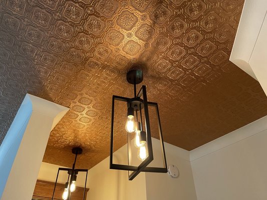 Metallic Paint Makeover - This was a very unique home with a very unique ceiling. The original owners built the home and added the embossed ceiling paper/laminate as sort of a 40’s tin ceiling look but the execution wasn’t the best. The new owners weren’t sure what to do with it but after a consultation and samples they ultimately decided to embrace the look with a copper metallic glaze finish. This isn’t for every home but wow does it look good in this one! Metallic Paint Makeover - This was a very unique home with a very unique ceiling. The original owners built the home and added the embossed ceiling paper/laminate as sort of a 40’s tin ceiling look but the execution wasn’t the best. The new owners weren’t sure what to do with it but after a consultation and samples they ultimately decided to embrace the look with a copper metallic glaze finish. This isn’t for every home but wow does it look good in this one!