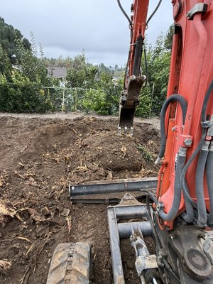 Tree Stump Removal - In this project we used our heavy equipment machinery to remove a large tree stump from this backyard.