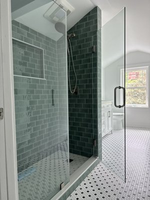 Bathroom Remodel - Full bathroom remodel featuring a custom walk-in shower with frameless glass, deep green subway tile, and classic hex flooring.

This space also includes a double vanity for added storage and function, updated fixtures, and a clean, modern layout throughout.

Designed for both everyday use and long-term durability.