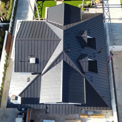 Standing Seam Metal Roof - 4,000 square feet of standing seam metal roof. 17" panel, 24g steel, matte black finish by Taylor Metal Products. This project was very detailed and steep with a pitch of 7/12. Standing Seam Metal Roof - 4,000 square feet of standing seam metal roof. 17" panel, 24g steel, matte black finish by Taylor Metal Products. This project was very detailed and steep with a pitch of 7/12.