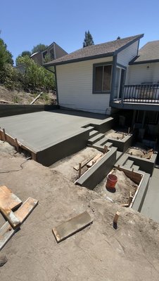 Backyard Patio Installation - We recently installed a fresh new backyard patio designed for both beauty and practicality. The project featured pour-in-place concrete walls that add structure and style while defining the space. To support the garden, we installed drip irrigation lines for the flower boxes, ensuring plants receive consistent, efficient watering. Proper drainage was carefully integrated to keep the area dry and prevent water buildup. For added ambiance and safety, low-voltage lights were installed along the steps, creating a warm, inviting glow in the evenings. The result is a functional and elegant outdoor living space perfect for relaxing and entertaining. Backyard Patio Installation - We recently installed a fresh new backyard patio designed for both beauty and practicality. The project featured pour-in-place concrete walls that add structure and style while defining the space. To support the garden, we installed drip irrigation lines for the flower boxes, ensuring plants receive consistent, efficient watering. Proper drainage was carefully integrated to keep the area dry and prevent water buildup. For added ambiance and safety, low-voltage lights were installed along the steps, creating a warm, inviting glow in the evenings. The result is a functional and elegant outdoor living space perfect for relaxing and entertaining.