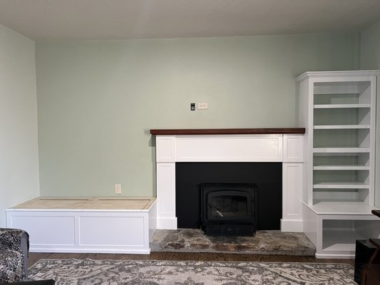 Fireplace mantle, window seat, bookcase and fire box - Designed, fabricated and installed new components to make a comfortable and functional living room. We removed what was left of the dated rock wall (the seating areas next to the existing fireplace) making sure to provide excessive protection to the wood floor. We worked with the client to make sure they got more than they expected from our service.