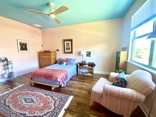 Before and After UP Bedroom and Powder Bathroom - My client wanted to enliven her bedroom and powder bathroom with vibrant colors. She chose a light blue ceiling color, a peach wall color and a bright decorative door arch over her closet door. For her powder bathroom, we installed a colorful botanical wallpaper, green paint and brass ceiling tile. The finishing touch was a piece of art perfect for the space. The results are stunning!