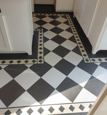 Black & White Forbo Marmoleum Floor with a Checkerboard Design - 🏁Another beautiful black & white checkerboard floor installed, this one complete with an elegant diamond border! 🔷 Marmoleum is a popular kitchen flooring choice because it's easy to clean and requires little maintenance.