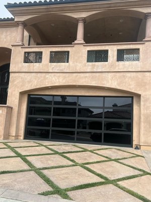 Full-view Glass Garage door - At A list Garage Door and Gate, we specialize in providing top-tier Full View Glass Garage Doors that seamlessly blend modern design with superior functionality. These doors feature sleek, high-quality tempered glass panels, framed in durable aluminum, offering an elegant, open look while maintaining the security and strength you need. Whether you’re looking to brighten your space with natural light or create a contemporary aesthetic for your home or business, our Full View Glass Garage Doors deliver. With professional installation from our expert team, you can count on a secure, long-lasting solution that enhances the curb appeal of your property.