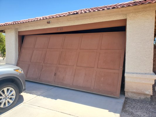 One Piece Conversion in Henderson - Robert received a call about an off track door, this can be very dangerous as there is tension pulling in multiple directions. It was an outdated one piece door that would take more time and money to repair than it's worth. Robert replaced everything. New Almond Short Panel Garage Door, all new hardware, including a new standard roll up torsion spring system.