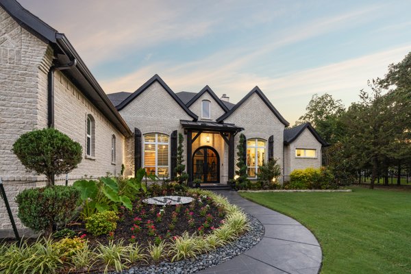 Beautiful Custom Walkways - This project showcases a custom-designed front walkway that dramatically elevates the curb appeal of the home. Using premium materials carefully selected to complement the home's brick and stone facade, our team crafted a sweeping, welcoming entrance that makes a lasting first impression. The walkway was designed with both aesthetics and function in mind, ensuring proper drainage, slip resistance, and long-term durability in the Texas climate. Our craftsmen hand-finished every detail to create clean lines and precise edging that ties the driveway, landscaping, and entrance together into one cohesive exterior design. From initial consultation through to completion, Allied managed the full scope of the project so the homeowners could enjoy a stunning result with zero hassle. Beautiful Custom Walkways - This project showcases a custom-designed front walkway that dramatically elevates the curb appeal of the home. Using premium materials carefully selected to complement the home's brick and stone facade, our team crafted a sweeping, welcoming entrance that makes a lasting first impression. The walkway was designed with both aesthetics and function in mind, ensuring proper drainage, slip resistance, and long-term durability in the Texas climate. Our craftsmen hand-finished every detail to create clean lines and precise edging that ties the driveway, landscaping, and entrance together into one cohesive exterior design. From initial consultation through to completion, Allied managed the full scope of the project so the homeowners could enjoy a stunning result with zero hassle.