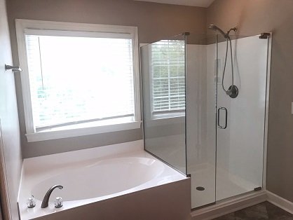 Bathroom Re-model - A corner glass shower door is a stylish and space-saving option designed for showers located in the corner of a bathroom. It typically features clear tempered glass panels and a sleek frame or frameless design, providing an elegant, open look while maximizing bathroom space.