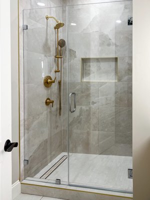 Step into luxury with our latest bathroom transformation! - Step into luxury with our latest bathroom transformation! Modern elegance: soothing grey tiles, complemented by simple gold fixtures that exude sophistication. The pièce de résistance? A stunning birch wood vanity, boasting ample storage and a sleek single sink design. Accent lights on the sides add a touch of ambiance and beauty. Experience the perfect blend of style and practicality in every corner! Step into luxury with our latest bathroom transformation! - Step into luxury with our latest bathroom transformation! Modern elegance: soothing grey tiles, complemented by simple gold fixtures that exude sophistication. The pièce de résistance? A stunning birch wood vanity, boasting ample storage and a sleek single sink design. Accent lights on the sides add a touch of ambiance and beauty. Experience the perfect blend of style and practicality in every corner!