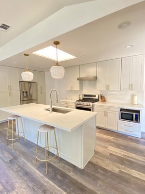 Kitchen remodel - This old kitchen and living area had many problems. From being a narrow galley style kitchen with dark and unwelcoming energy, it lacked personality and charm. With the opening of walls and added lighting we were able to transform this small kitchen space and living room into a lively open area to cook and entertain.