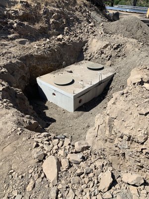Septic Tank Replacement - The Septic Tank Replacement was performed in Santa Rosa at a fire rebuild property. The existing tank was compromised and in need of replacement. Taurian Constuction installed a new 1200 gallon concrete septic tank and abandoned the previous tank. The site conditions at this job site consisted of large rock and hard pan and required the use of additional equipment to place the Tank. If you are in need to a Septic Installation Contractor, Call Taurian Construction. No job is too difficult for our experienced team. Septic Tank Replacement - The Septic Tank Replacement was performed in Santa Rosa at a fire rebuild property. The existing tank was compromised and in need of replacement. Taurian Constuction installed a new 1200 gallon concrete septic tank and abandoned the previous tank. The site conditions at this job site consisted of large rock and hard pan and required the use of additional equipment to place the Tank. If you are in need to a Septic Installation Contractor, Call Taurian Construction. No job is too difficult for our experienced team.