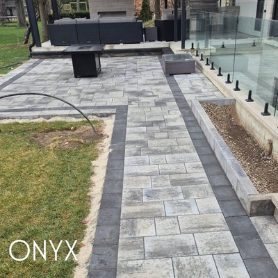 Project 3a-2025 - Precision in every pattern.
This project features a sleek, modern design using premium interlock bordered with contrasting stone for bold definition. Whether it’s the side of the home, a backyard pathway, or a front entrance, our team delivers clean lines and seamless transitions that elevate the entire property.

Crafted with care by Onyx Custom Solutions
Mississauga | Brampton | GTA