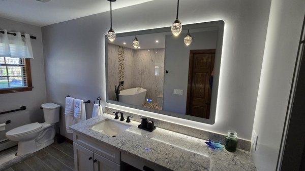 Bathroom Remodel - This was a complete renovation of the bathroom and walk in closet. The bathroom included a package of recessed lights, bathroom fan, light, heat. Touch screen mirror with accent pendants. Bathroom Remodel - This was a complete renovation of the bathroom and walk in closet. The bathroom included a package of recessed lights, bathroom fan, light, heat. Touch screen mirror with accent pendants.