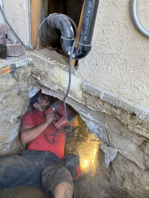 Back up stoppage for tub drain due to broken pipe - We arrived to an emergency call on a Saturday at 10:30 pm. Initially we were called for the tub stoppage. We tried snaking this drain for over an hour and were unable to clear stoppage. We determine since it was back to back tub layout, as well as a continuing issue for a costumer(not the first time they had stoppage) that it is best to perform a proper repair. 
On top of that, a laundry drain was improperly installed and tapped directly into already compromised tub drains.  Since this home is on slab, we had to tunnel below said slab from the exterior of home.  It was a hard job but it was completed in a 2 day span.  
This work comes with 6 year warranty for our costumer
