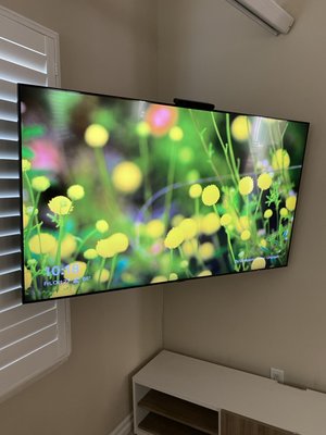 Residential TV installation - Customer chose a full motion corner mount system for 70” TV to fit behind previously mounted cinema screen when in use, TV can now lay flat against either wall or be diagonal for optimal viewing angle. Residential TV installation - Customer chose a full motion corner mount system for 70” TV to fit behind previously mounted cinema screen when in use, TV can now lay flat against either wall or be diagonal for optimal viewing angle.
