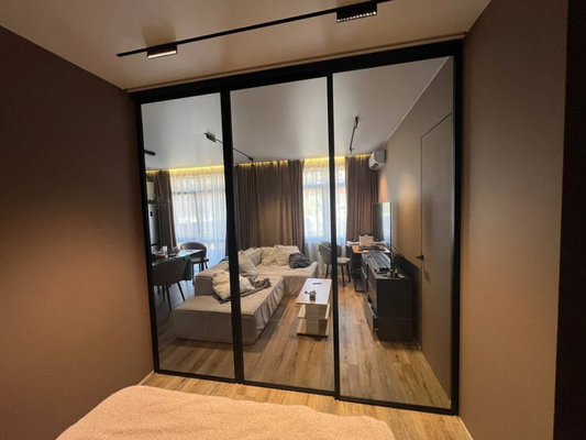 Sliding Glass Partition – Black Perimeter Frame - A sleek sliding glass partition installed to separate a bedroom from the living area in a modern apartment. The minimalist design features clear tempered glass framed only along the perimeter in matte black — preserving openness while subtly dividing the space. The top-hung sliding system ensures smooth operation without floor tracks, keeping the visual flow clean and uninterrupted.
🔹 Black perimeter frame for a refined, modern look
🔹 Top-mounted sliding system — no bottom track
🔹 Clear tempered glass for maximum light flow
🔹 Custom-fit to integrate seamlessly into the layout
📐 Request a quote — we’ll design a solution tailored to your space. Sliding Glass Partition – Black Perimeter Frame - A sleek sliding glass partition installed to separate a bedroom from the living area in a modern apartment. The minimalist design features clear tempered glass framed only along the perimeter in matte black — preserving openness while subtly dividing the space. The top-hung sliding system ensures smooth operation without floor tracks, keeping the visual flow clean and uninterrupted.
🔹 Black perimeter frame for a refined, modern look
🔹 Top-mounted sliding system — no bottom track
🔹 Clear tempered glass for maximum light flow
🔹 Custom-fit to integrate seamlessly into the layout
📐 Request a quote — we’ll design a solution tailored to your space.