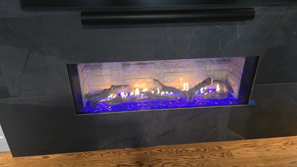 Primo II Linear Gas Fireplace - Builders bring us in early — right after framing — so the finish work can happen around the fireplace instead of fighting it, often before gas is even set at the home. These photos show the full arc: venting run inside the walls, the low-profile vent termination outside, and first light-off.
At the very end, we come back to detail the unit, set the logs, confirm the gas connection, and run it through its paces so it's ready the day the new homeowners get their keys.
This one is Heat & Glo's Primo II, a clean, modern linear gas fireplace available in 48-, 60-, and 72-inch widths. The look is customizable — log sets, glass or rock firebed, interior panels, and LED lighting the homeowner controls. It puts out real heat and runs from a touchscreen remote, wall switch, or the IntelliFire app. A double-sided see-through version is available for rooms that share a wall. Primo II Linear Gas Fireplace - Builders bring us in early — right after framing — so the finish work can happen around the fireplace instead of fighting it, often before gas is even set at the home. These photos show the full arc: venting run inside the walls, the low-profile vent termination outside, and first light-off.
At the very end, we come back to detail the unit, set the logs, confirm the gas connection, and run it through its paces so it's ready the day the new homeowners get their keys.
This one is Heat & Glo's Primo II, a clean, modern linear gas fireplace available in 48-, 60-, and 72-inch widths. The look is customizable — log sets, glass or rock firebed, interior panels, and LED lighting the homeowner controls. It puts out real heat and runs from a touchscreen remote, wall switch, or the IntelliFire app. A double-sided see-through version is available for rooms that share a wall.