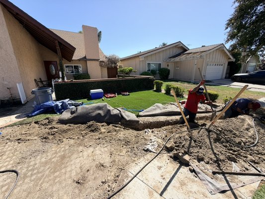 Main Water Line Replacement in Cypress - Replaced the main water line at this Cypress home. These photos show the work at the house connection, the trench across the front yard, and the yard after it was restored.