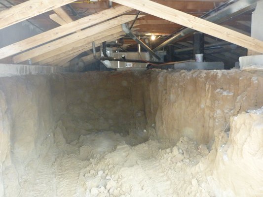 Crawlspace to basement conversion - Conversion of a crawlspace to basement on one half of a masonry duplex. Helical piers were installed from the exterior for temporary support and to be incorporated into the final foundation. After piers were placed, we excavated a ramp into the basement for skid-steer excavation and soil removal. At the completion of excavation, a drain and permanent foundation was installed Crawlspace to basement conversion - Conversion of a crawlspace to basement on one half of a masonry duplex. Helical piers were installed from the exterior for temporary support and to be incorporated into the final foundation. After piers were placed, we excavated a ramp into the basement for skid-steer excavation and soil removal. At the completion of excavation, a drain and permanent foundation was installed