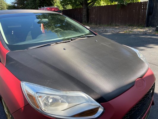 Carbon Fiber wrap - This Ford Focus came in for a hood, roof, and trunk wrap. All wrapped in carbon fiber. Carbon Fiber wrap - This Ford Focus came in for a hood, roof, and trunk wrap. All wrapped in carbon fiber.