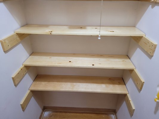 Custom Pine Storage Shelves - Our client wanted additional storage shelves for cleaning supplies in one of her closets. She specified white pine with a simple polyurethane finish. We measured her space, cut and finished the wood in our shop, and then installed. Custom Pine Storage Shelves - Our client wanted additional storage shelves for cleaning supplies in one of her closets. She specified white pine with a simple polyurethane finish. We measured her space, cut and finished the wood in our shop, and then installed.