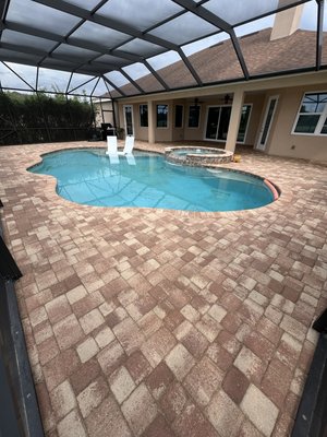 Pool deck in Merritt Island. - This pool deck had a few pavers settling around the perimeter. We picked up the pavers in those areas and, during the repair, discovered a pool leak in the spa area. We assisted the customer in contacting a pool company to fix the leak. Afterward, we re-leveled the base foundation and re-installed the pavers. We then proceeded with a deep cleaning of the pavers, re-sanded the joints, and applied a high-quality semi-gloss sealer. This gave the pavers a nice wet look with a subtle sheen, but not overly shiny. The customer was very happy with the results. Pool deck in Merritt Island. - This pool deck had a few pavers settling around the perimeter. We picked up the pavers in those areas and, during the repair, discovered a pool leak in the spa area. We assisted the customer in contacting a pool company to fix the leak. Afterward, we re-leveled the base foundation and re-installed the pavers. We then proceeded with a deep cleaning of the pavers, re-sanded the joints, and applied a high-quality semi-gloss sealer. This gave the pavers a nice wet look with a subtle sheen, but not overly shiny. The customer was very happy with the results.