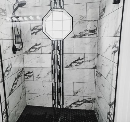 Primary Suite Bathroom Remodel - Check out this stunning full bathroom remodel project we recently completed! Our team had to completely gut the space due to rotted flooring and mold caused by poor insulation installation from the previous builder. We worked closely with the homeowner to design the space of her dreams, which included a beautiful tiled shower, a raised and painted vanity, brand new countertops, flooring, and lighting. She gave us the design and our team ran with it!