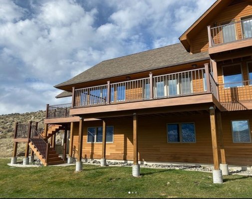 New Deck - We do more than roofing! Check out this amazing deck we completed for our wonderful clients in Gardiner. This perfectly matching, multi-level, gorgeous deck completed their home and increased the value! Plus, look at that view!