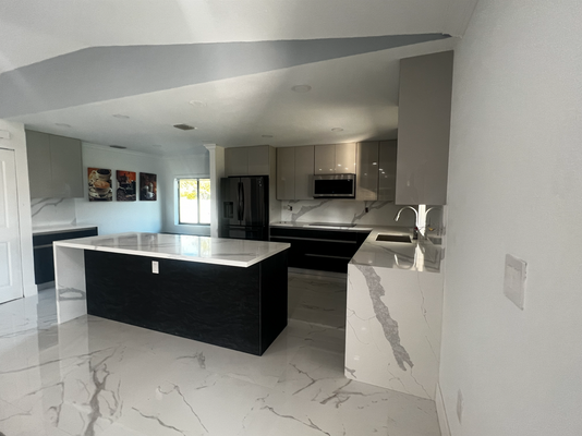 Alina's Kitchen - This project was a complete kitchen transformation, taking the space from a traditional, dated design to a modern and minimalist kitchen with high-end finishes. The original layout and cabinetry were fully removed to make way for a clean-lined design, sleek surfaces, and a more open, contemporary feel. The finished kitchen features a bold contrast of materials, refined details, and a streamlined layout that completely redefines the space.