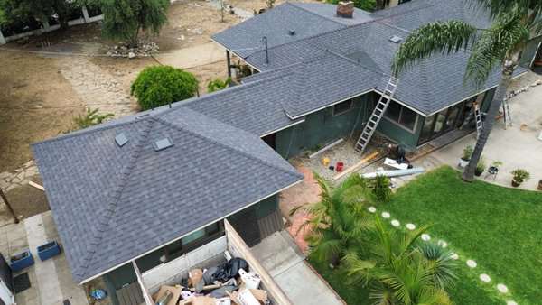 Full Roof Replacement — Tear-Off to Finished Shingle System (Aerial Views) - Complete reroof shown from start to finish. Photos capture the tear-off and deck prep phase, followed by the finished architectural shingle installation across multiple roof planes. The final result shows clean ridge/hip lines, consistent shingle layout, and a uniform, finished look throughout the property. Full Roof Replacement — Tear-Off to Finished Shingle System (Aerial Views) - Complete reroof shown from start to finish. Photos capture the tear-off and deck prep phase, followed by the finished architectural shingle installation across multiple roof planes. The final result shows clean ridge/hip lines, consistent shingle layout, and a uniform, finished look throughout the property.