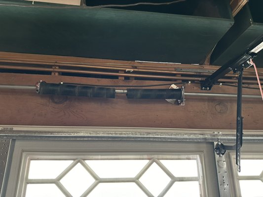 Broken torsion spring. - If you are having trouble trying to open your garage door that goes up about 3-4 inches off the floor and stops look up and look for a broken spring you will probably see a separation of the coils and most likely you have a broken spring. Broken torsion spring. - If you are having trouble trying to open your garage door that goes up about 3-4 inches off the floor and stops look up and look for a broken spring you will probably see a separation of the coils and most likely you have a broken spring.