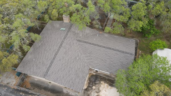 Three-Tab to Architectural Shingles — Before & After - Barnes N' Roofs replaced this home's old three-tab asphalt shingles with architectural shingles. Four before-and-after photographs show the original roof and completed roofing across the connected roof sections. The aerial views let homeowners compare the appearance of the previous three-tab roof with the finished architectural shingle replacement. Three-Tab to Architectural Shingles — Before & After - Barnes N' Roofs replaced this home's old three-tab asphalt shingles with architectural shingles. Four before-and-after photographs show the original roof and completed roofing across the connected roof sections. The aerial views let homeowners compare the appearance of the previous three-tab roof with the finished architectural shingle replacement.