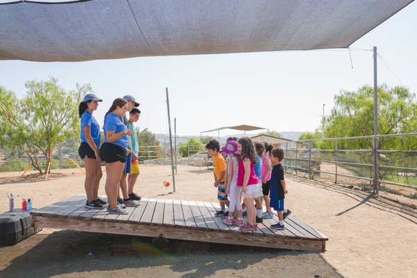 Our Philosophy - Founded in 1954 by two educators, Camp Kinneret is a loving community rooted in child development. Choosing Camp Kinneret means that, as a parent, you know that a caring team of child-development professionals will be investing in your child. We’ll be taking the time to know them, welcoming your camper by name, and ensuring that they are connecting with the other campers and the staff. All without the distractions of modern technology.

No cell phones.
No tablets.
No screens.
Unplugged.

Old-fashioned fun where children develop social skills, practice critical thinking, share a community mindset, and learn to persevere when things get hard.

The things we do at Camp Kinneret aren’t new (we’ve been doing them since 1954!), but they have new meaning in today’s technological world. We believe that children need more time developing the social and emotional skills that form the core of every happy, healthy adult. That’s why we spend so much time and energy finding, interviewing, training, and supporting our staff members each summer. We know the value of a dedicated staff who will invest in your child’s growth and well-being. We also select an experienced Leadership Team to partner with parents and ensure that we are actively working with each and every child to help them to grow into the best version of themselves. We are parental in our approach – looking for untied shoes, prioritizing sunscreen and water, and watching for small cues that may indicate that some extra attention would help.

Camp Kinneret Is…
A place where creativity and expression are encouraged
A program in which teamwork and social interaction are the basics
A community where the courage to try is celebrated and the desire to succeed is supported
An opportunity for children to grow through accomplishment and respect

Camp Kinneret is an experience that words cannot adequately describe. Our focus on relationships and providing children with opportunities to learn, grow and discover themselves is at the heart of the Camp Kinneret philosophy. Our attitude and approach to everything we do at camp focuses on creating a warm, welcoming environment in which kids can be themselves without fear of judgment and in which each child belongs. Our child-centered philosophy creates a supportive atmosphere where campers develop skills and values to last a lifetime. We call it a child-centered program, the campers call it the best summer ever!

At Camp Kinneret, We Believe In:
Building better people.
Teaching skills for life.
Facilitating growth.
Noticing and embracing everyday lessons.
Fostering a supportive community.
Practicing our Kinneret Roots.*
Encouraging independent voices in campers and staff.
Nurturing self-expression, imagination, and creativity.
Demonstrating honesty and integrity at our core.
Returning campers in better shape than when they arrived.
Maintaining an inclusive and diverse camp population.
Enjoying time outdoors and in nature.
Appreciating social interactions away from technology.
Having fun!