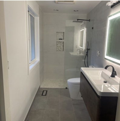 Bathroom Remodeling Project - This bathroom was remodeled for a functional and modernized aesthetic style. The old bathroom was outdated and lacked a newer design. The colors of the original designs didn't stand out, the vanity and sink cabinets were bland and looked out of style, so the client reached out to me about a more modernized bathroom look. We began remodeling by removing the old tiles. We replaced the cabinets and vanity mirrors with a newer and more modern look. And Instead of the small tub we gave the bathroom a walk in shower which gives not only a better look but more spacious as well. These are the before and after of this bathroom remodeling.