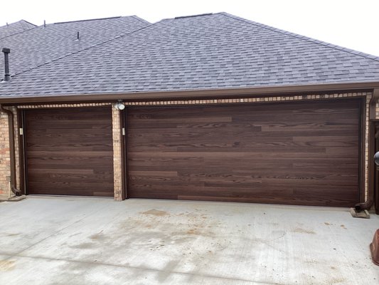 Dark Oak Plank Style Garage Doors - Looking to upgrade for your home? This customer chose to upgrade to two new Dark Oak Plank Style garage doors! They give you the high-end look of wood, without all of the extra maintenance that comes along with wood doors! Ready to make the change? Contact us today for your free on-site estimate with one of our Certified Service Professionals! You can reach us at (972)-422-1695 or PlanoOverhead.com/contact-us/ Dark Oak Plank Style Garage Doors - Looking to upgrade for your home? This customer chose to upgrade to two new Dark Oak Plank Style garage doors! They give you the high-end look of wood, without all of the extra maintenance that comes along with wood doors! Ready to make the change? Contact us today for your free on-site estimate with one of our Certified Service Professionals! You can reach us at (972)-422-1695 or PlanoOverhead.com/contact-us/
