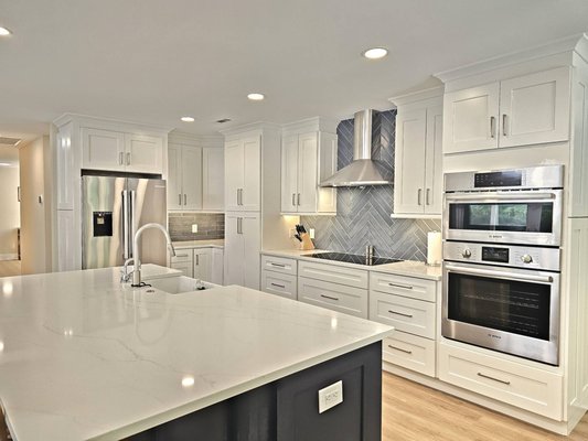 From Four to Five: Luxury Rental Remodel with Structural Restoration - This transformation reimagined a 4-bedroom, 4-bath home into a 5-bedroom, 5-bath luxury rental without increasing its footprint. The redesign added a new fifth bedroom with a private en-suite, reconfigured the layout so every bedroom enjoys its own bathroom, and right-sized the oversized primary bath to make space for new additions. The kitchen was fully remodeled with custom cabinetry, upgraded appliances, a hidden walk-in pantry, and finishes built to withstand short-term rental traffic. Structural repairs included replacing rotted framing, building a new CMU block foundation, and upgrading the pool deck drainage for long-term stability. The result is a stylish, guest-friendly property designed for both comfort and durability.

Project Key Features:
*Converted a 4-bedroom, 4-bathroom layout into a 5-bedroom, 5-bathroom rental property
*Designed and added a fifth bedroom with a private en-suite
*Reconfigured floorplan and circulation to provide en-suite bathrooms for all bedrooms
*Redesigned and reduced the oversized primary bathroom to free up space for new additions
*Fully remodeled the kitchen with: New cabinetry, fixtures, and finishes.
*A hidden walk-in pantry concealed behind matching cabinet doors
*Upgraded appliances to suit rental use
*Installed durable, high-end materials throughout to meet the demands of short-term rental traffic
*Addressed significant structural rot at the rear wall due to water intrusion: Removed and replaced damaged framing
*Built a new CMU block foundation for long-term stability
*Upgraded the pool deck drainage system to prevent future damage
*Created a functional, guest-friendly layout without expanding the home’s original footprint

The completed remodel delivered a stunning, highly functional 5-bedroom, 5-bath layout tailored for luxury short-term rentals. Every bedroom now features its own private en-suite, offering guests comfort and privacy. The reconfigured floor plan flows seamlessly, with a fully remodeled kitchen at its heart—complete with custom cabinetry, upgraded appliances, a hidden walk-in pantry, and durable high-end finishes built to withstand heavy rental traffic. Structural integrity was restored by replacing damaged framing, constructing a new CMU block foundation, and installing an upgraded pool deck drainage system to prevent future issues. The result is a beautifully finished, guest-friendly retreat that blends style, durability, and smart design—perfect for hosting memorable Lowcountry stays.